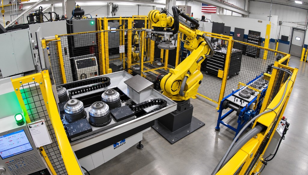 yellow FANUC robot tending a Midaco cell